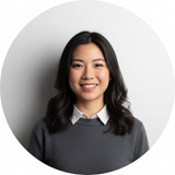 Portrait of Katherine Wu, an Asian woman smiling confidently, wearing smart casual attire against a clean white background.