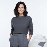 Portrait of Emma Wright, a stylish woman with dark hair and a confident smile, looking directly at the camera against a brigh